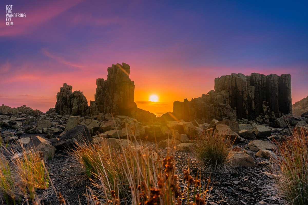 Purple orange skies illuminating the basalt columns during a sunrise at Bombo Headland Quarry Geological Site.