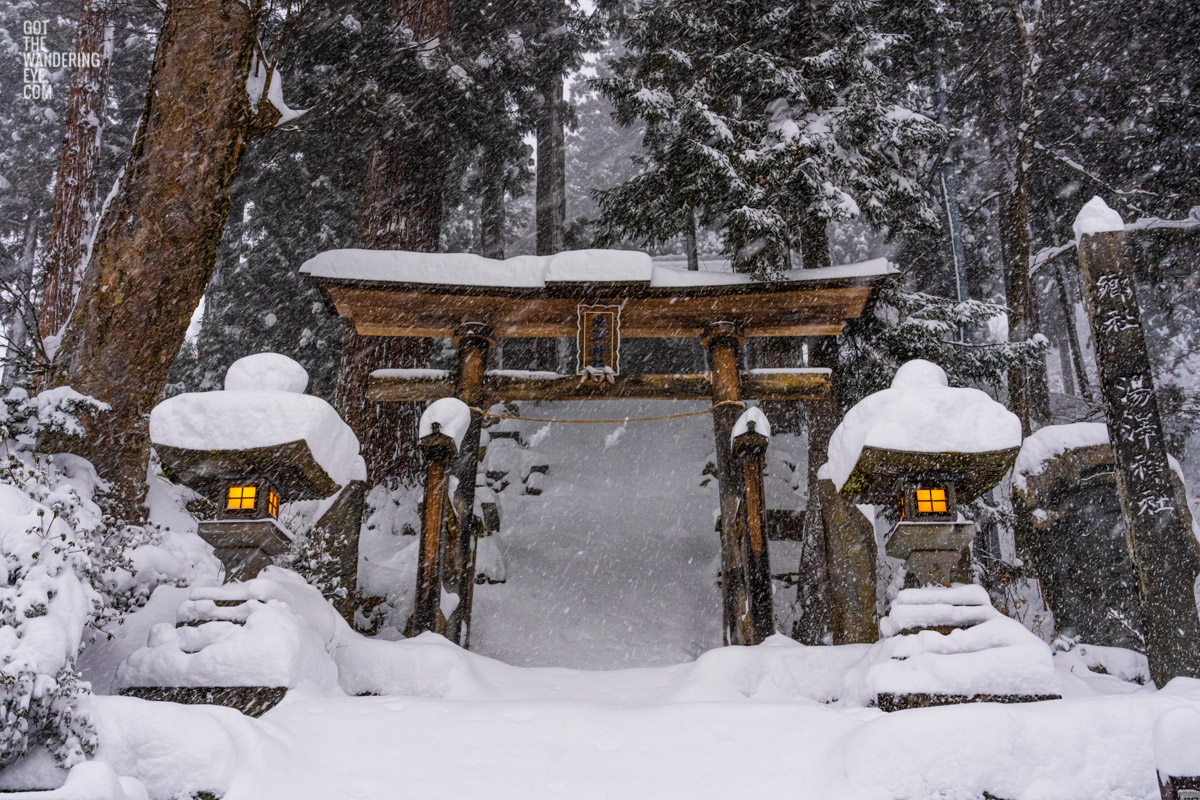 Japanese Lanterns illuminated as a metre of snow decends and covers the Yuzawa Shrine during winter in Nozawa Onsen.