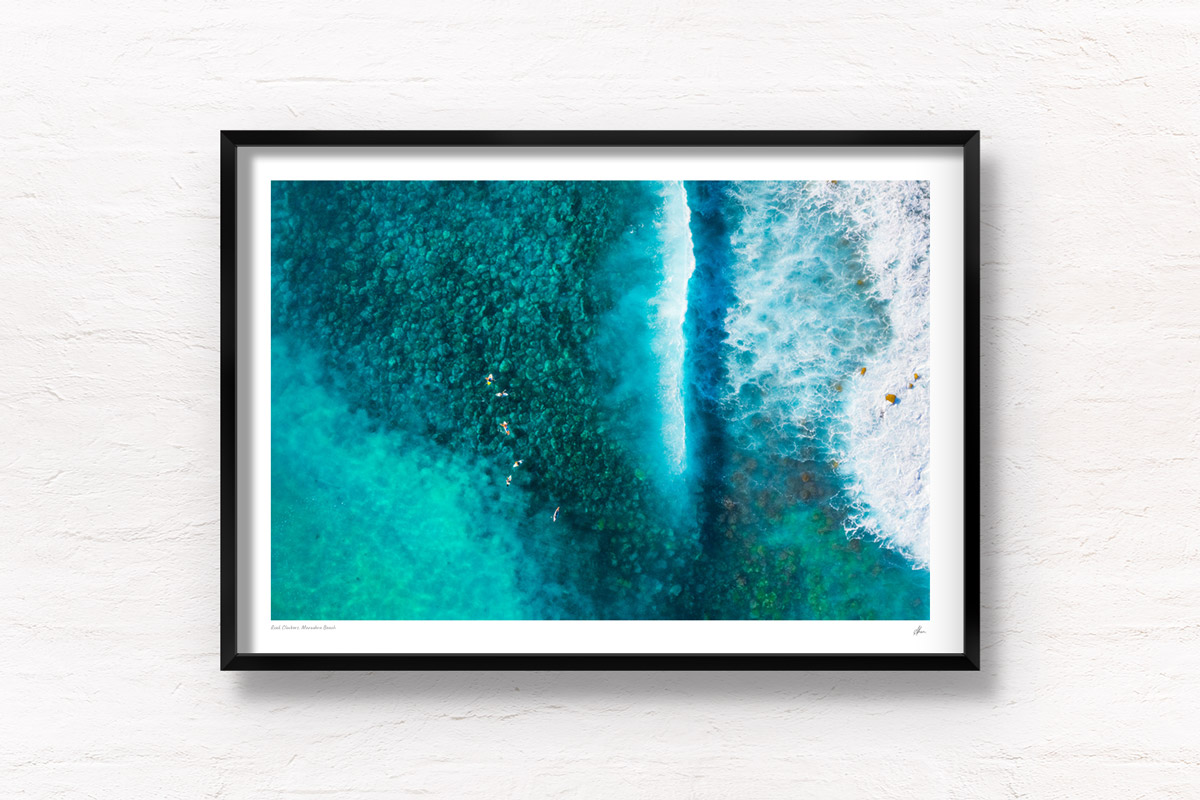 Aerial above surfers waiting for waves at Maroubra Beach. Framed art photography wall art print.
