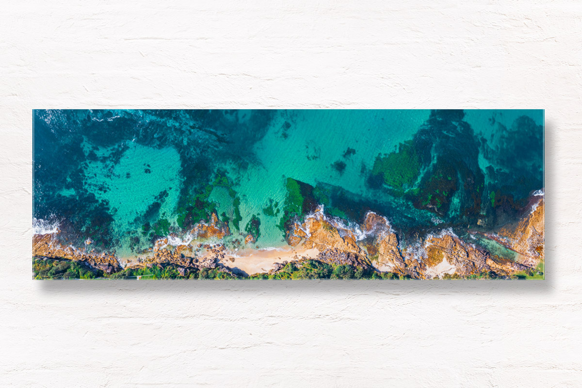 Aerial photography above Blackwoods Beach Cronulla. Clear crystal waters in Gods Country. Framed art photography wall art print.