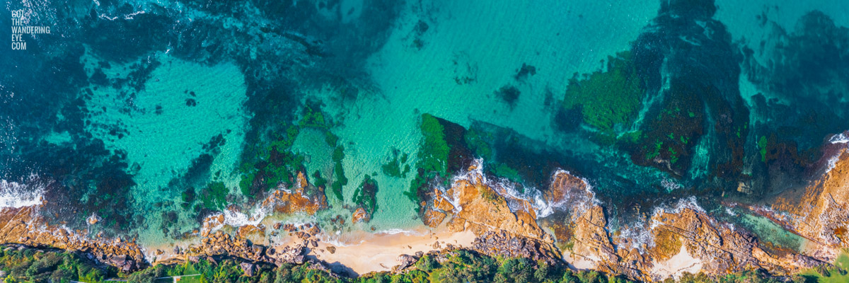 Aerial photography above Blackwoods Beach Cronulla. Clear crystal waters in Gods Country. Framed art photography wall art print.