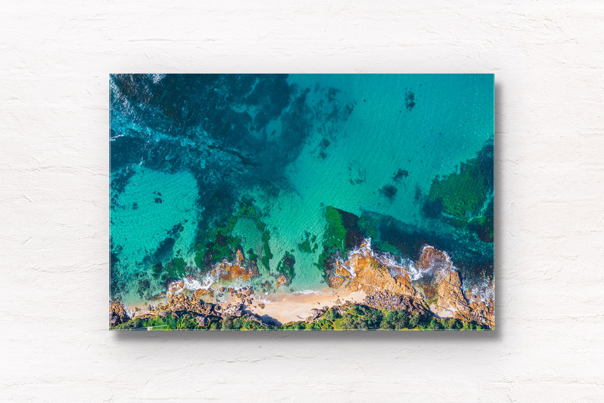 Aerial photography above Blackwoods Beach Cronulla. Clear crystal waters in Gods Country. Framed art photography wall art print.
