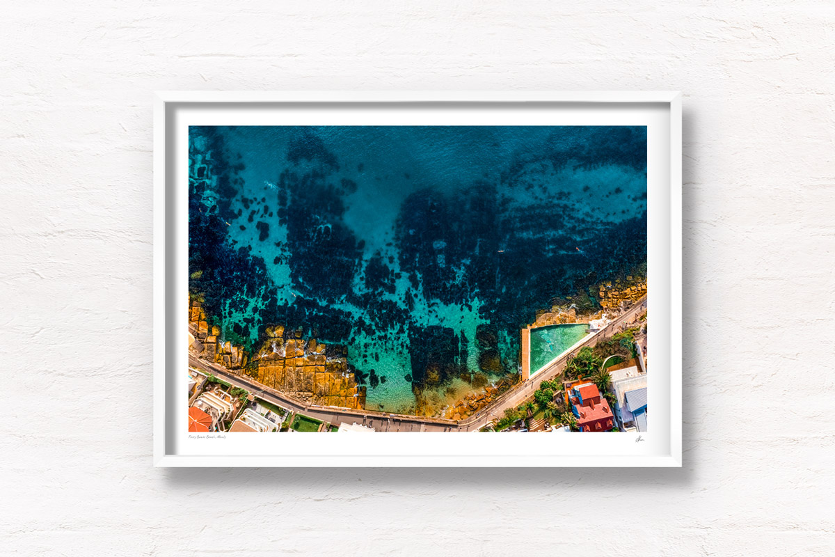 Aerial view above crystal clear Fairy Bower Beach and Fairy Bower Rock Pool. Framed art photography wall art print.
