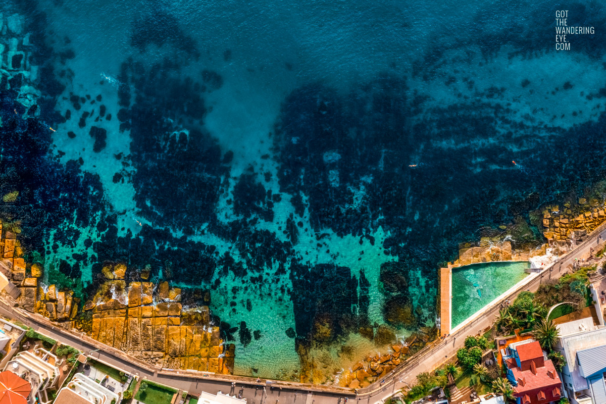 Aerial view above crystal clear Fairy Bower Beach and Fairy Bower Rock Pool.