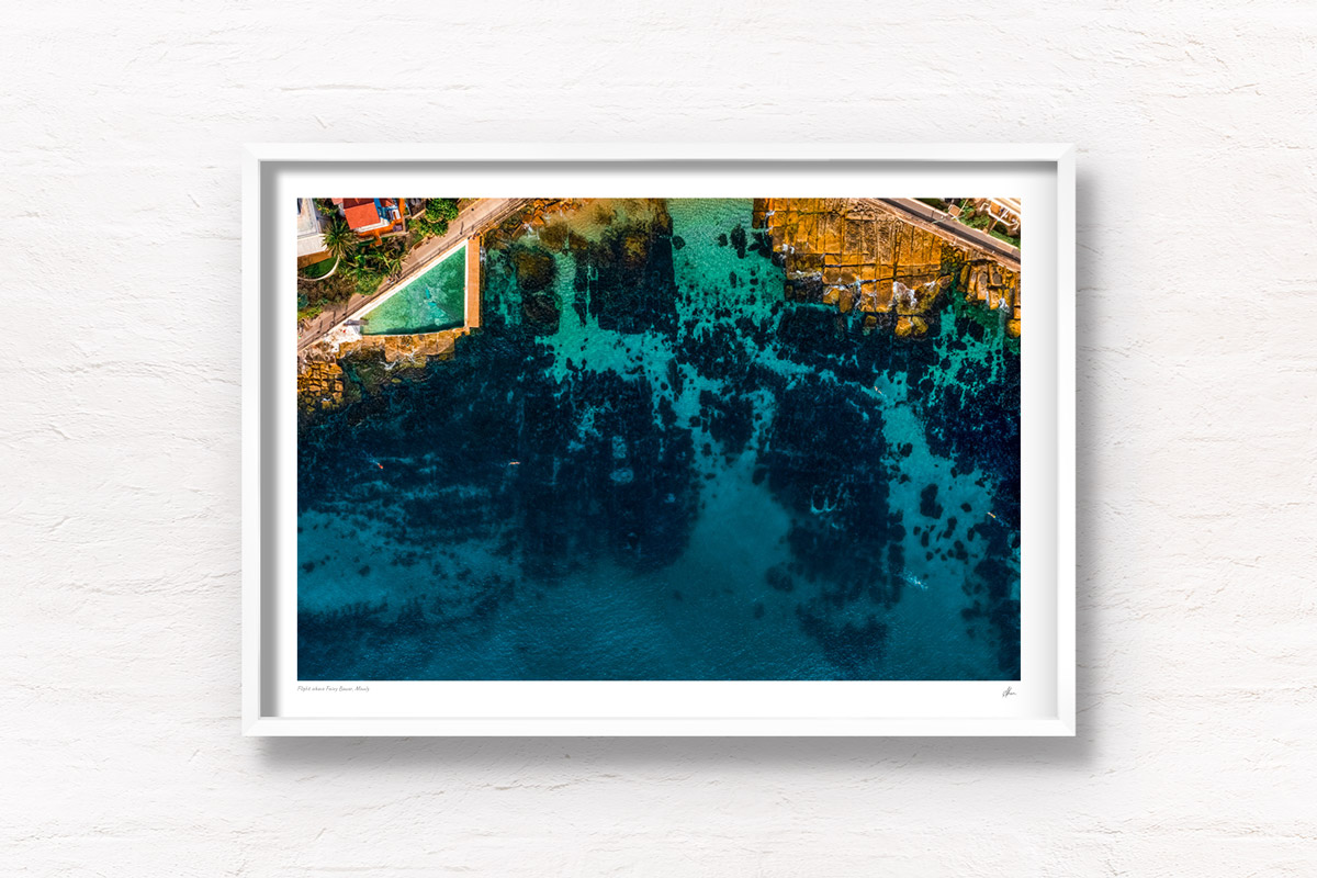 Aerial view above beautiful blue Fairy Bower rock pool and beach. Framed art photography wall art print.