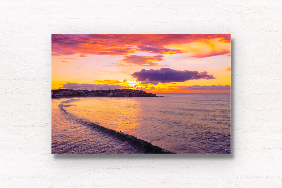 Slice of Bondi Beach. Long wave breaking during a beautiful golden pink sunrise over Ben Buckler Bondi. Framed art photography wall art print.