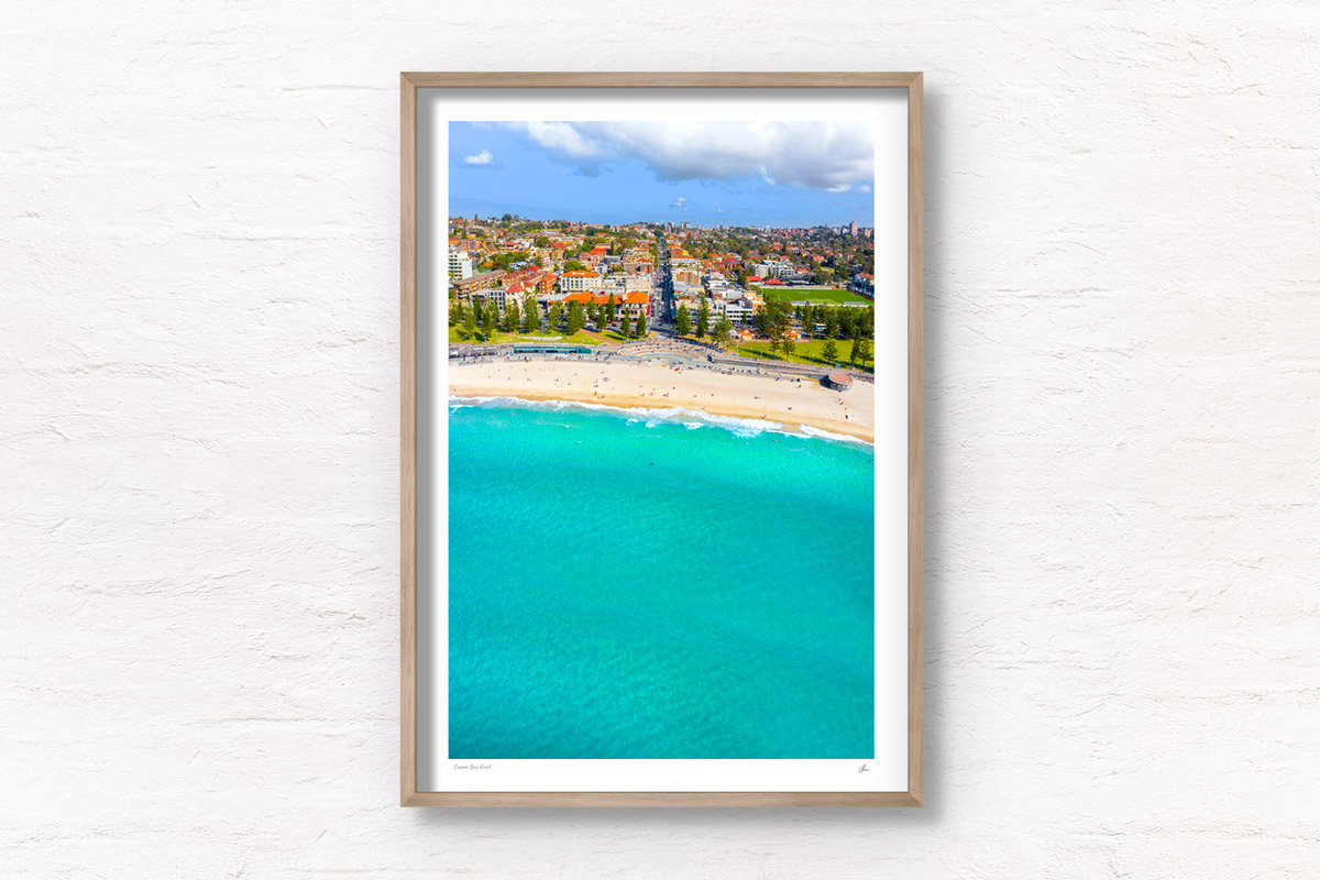 Aerial photography above turquoise clear ocean at Coogee Beach. Framed art photography wall art print.
