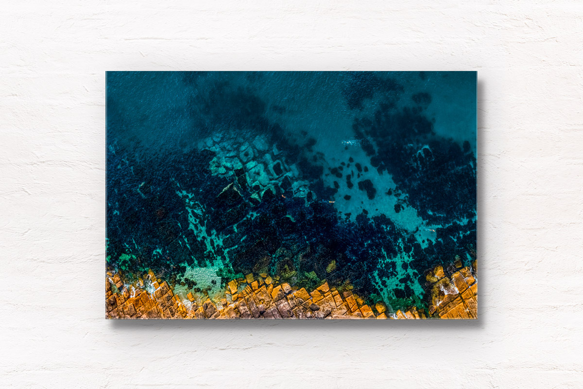 Aerial top down view above swimmers at Fairy Bower Beach's crystal clear waters. Framed art photography wall art print by Allan Chan.