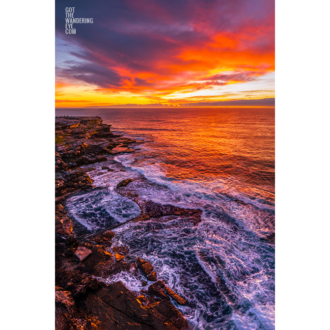 Aerial view of a blazing sunrise over Sydneys best ocean rock pool, Mahon Pool, Maroubra.