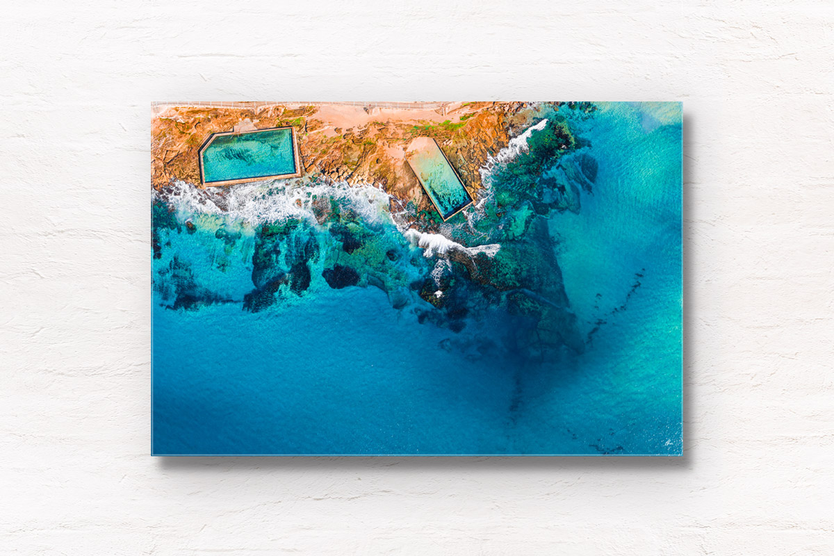 Aerial view above the Cronulla rockpools on a clear day and aqua coloured water. Framed art photography wall art print.