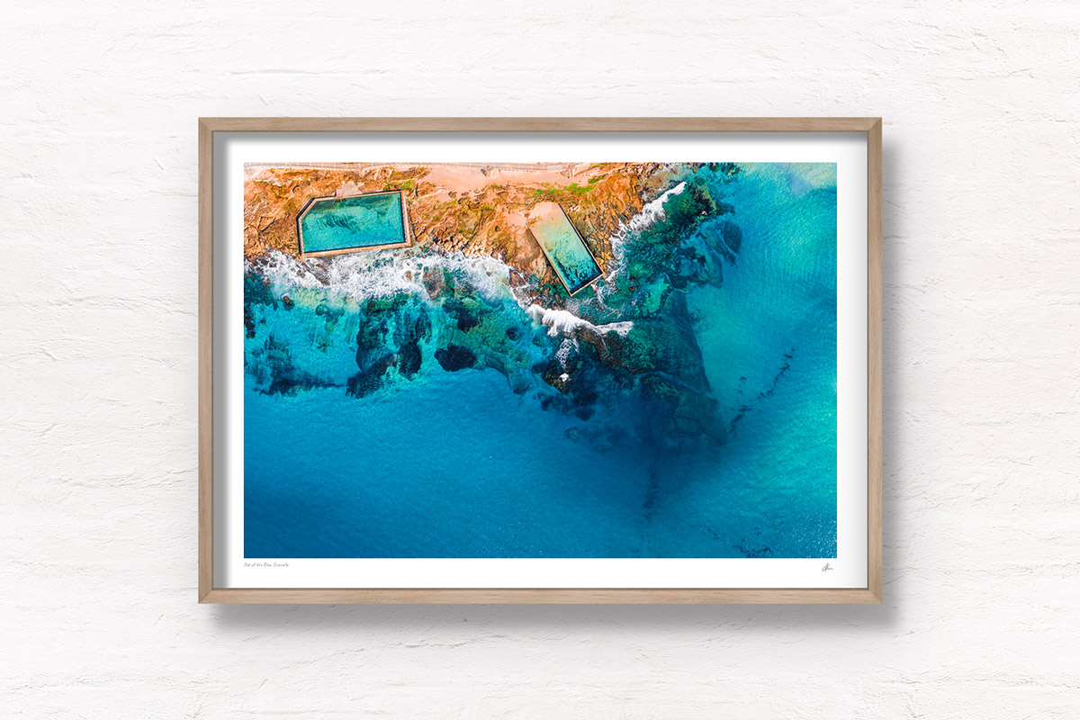 Aerial view above the Cronulla rockpools on a clear day and aqua coloured water. Framed art photography wall art print.