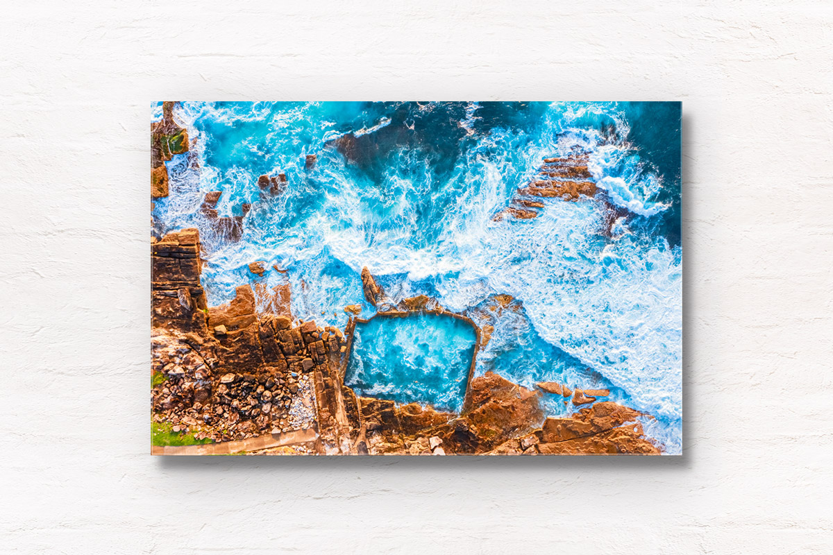 Aerial view above blue waters crashing over Mahon Pool in Maroubra. Framed art photography wall art print by Allan Chan.