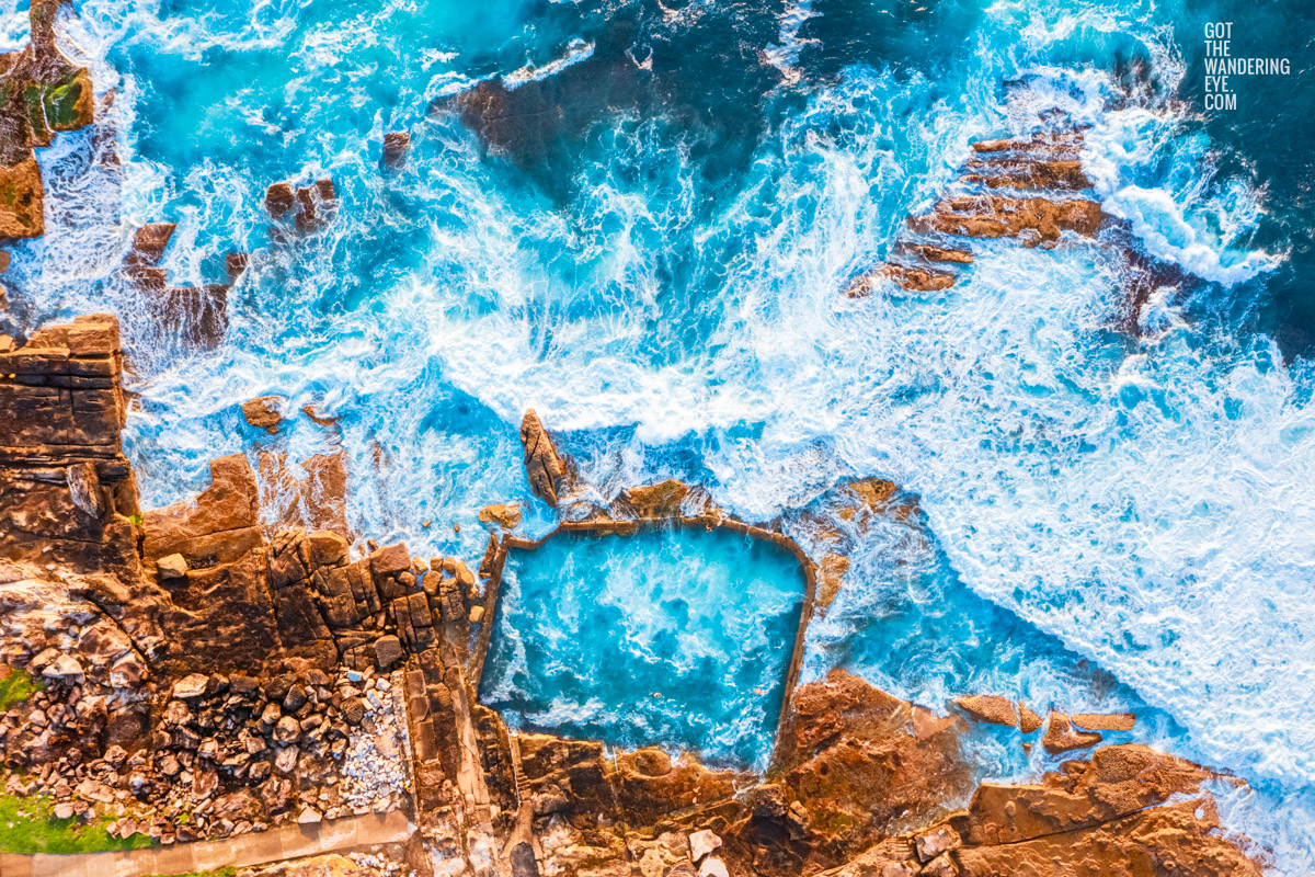 Aerial view above blue waters crashing over Mahon Pool in Maroubra.