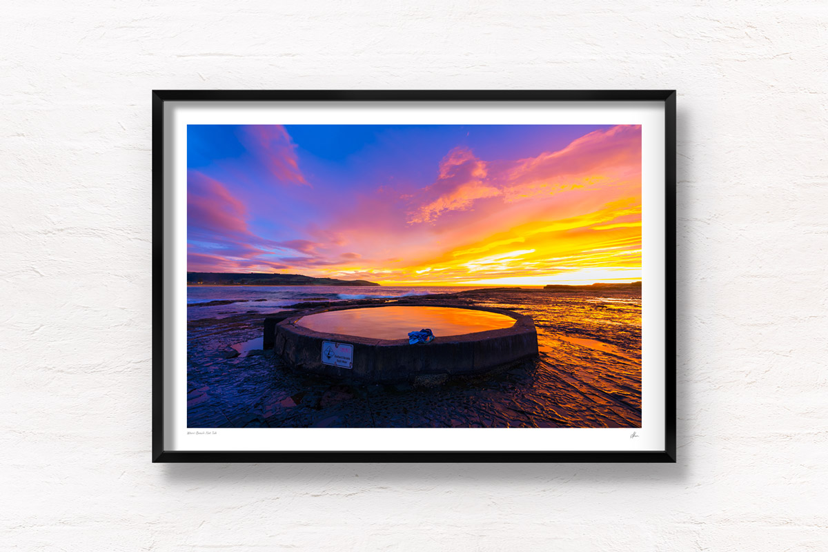 Purple and orange sunrise fluffy clouds above Werri Beach and round ocean rock pool. Framed art photography wall art print by Allan Chan.