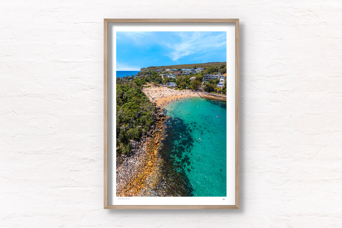 Aerial photo above Shelly Beach of swimmers enjoying a summers day in Manly. Framed art photography wall art print by Allan Chan.