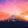 Mount Fuji Candlelight Sunset. Whispy clouds surrounding the peak of Mount Fuji on a golden pink sunset.