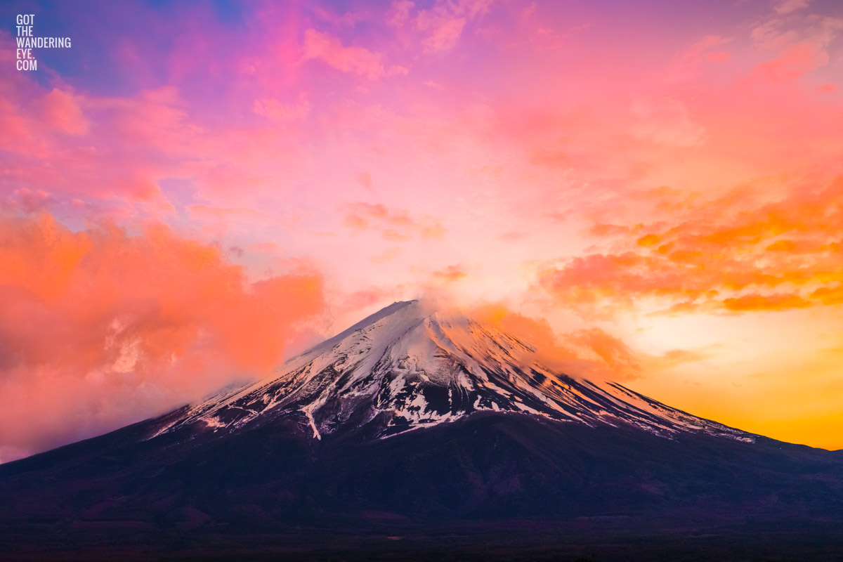 Mount Fuji Candlelight Sunset. Whispy clouds surrounding the peak of Mount Fuji on a golden pink sunset.