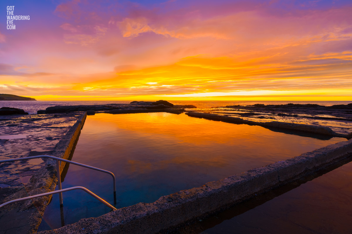 Sunkissed Werri Beach Rockpool during a spectacular morning sunrise in NSW South Coast.