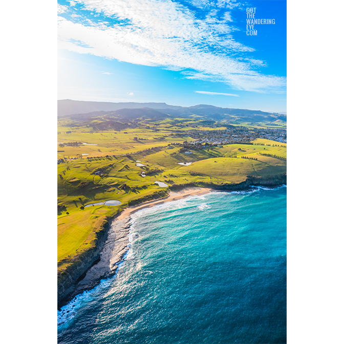 Walkers Beach Gerringong. Aerial view above the secluded and spectacular secret beach. Rolling green hilll landscape views in the background.