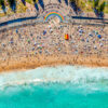 Aerial photography above a crowded Rainbow Walkway Coogee Beach on a Summers Day.