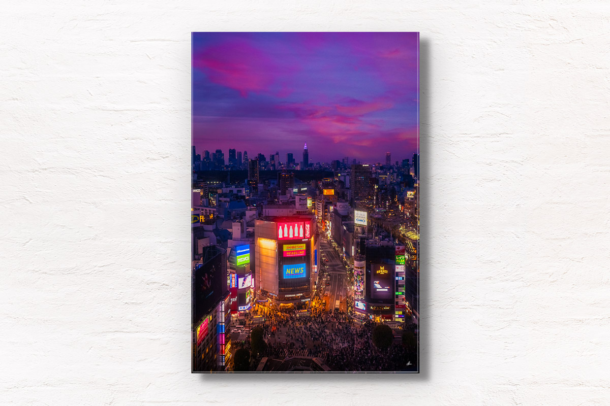 Neon Nights Shibuya Crossing. Aerial view of the city lit up at night during a purple and pink sky sunset. Framed art photography, wall art prints by Allan Chan.