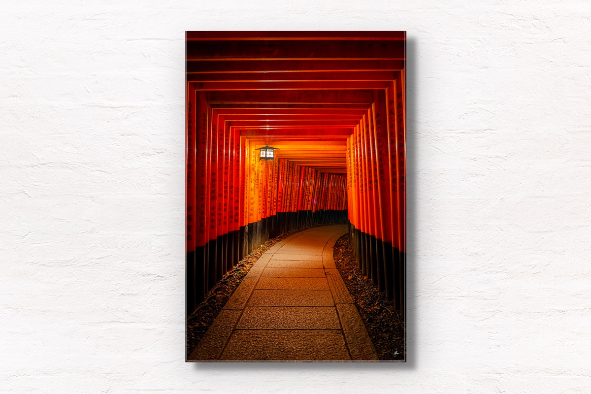 Lone Lantern Fushimi Inari Shrine. 1000 red torii gates from Kyoto lit at night by a lantern. Framed art photography, wall art prints by Allan Chan.