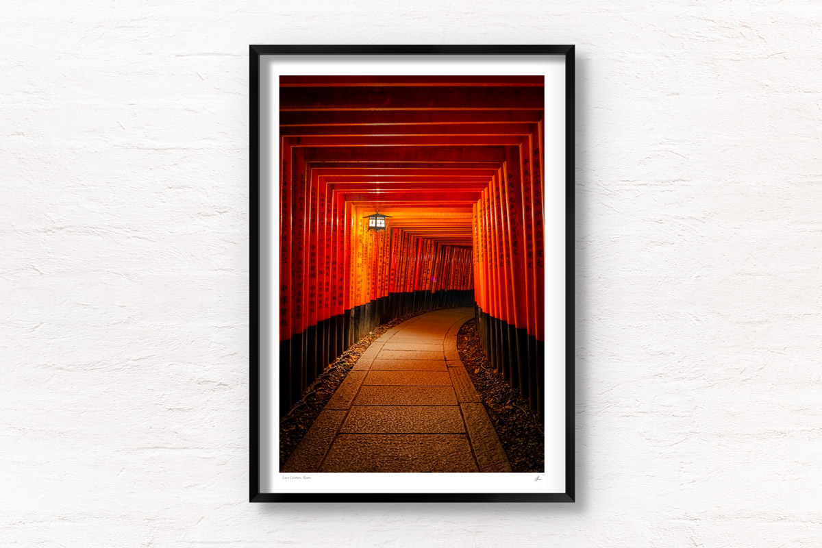 Lone Lantern Fushimi Inari Shrine. 1000 red torii gates from Kyoto lit at night by a lantern. Framed art photography, wall art prints by Allan Chan.