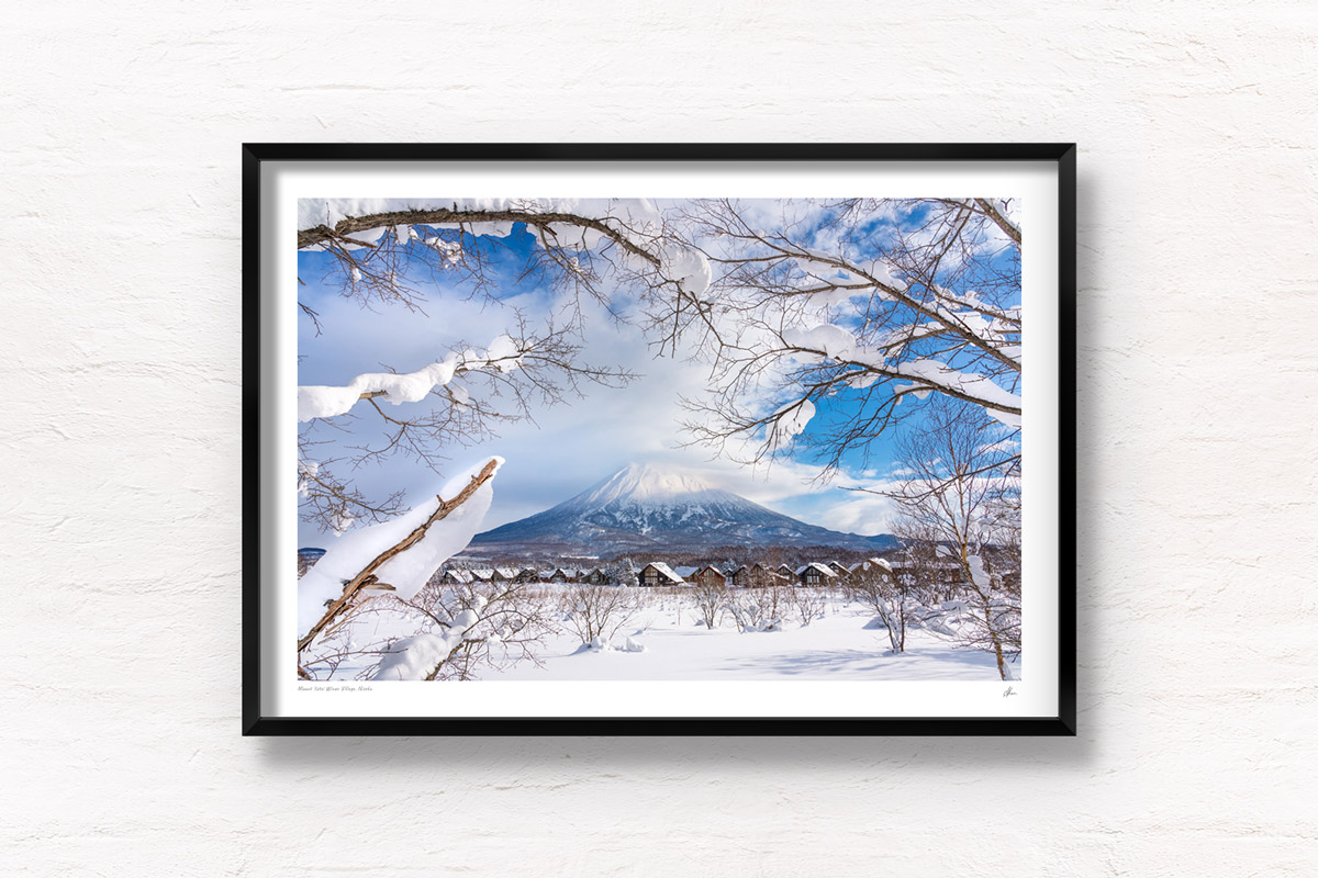 Mount Yotei Winter Village in Niseko on a snowy blue sky day. Framed art photography, wall art prints by Allan Chan.