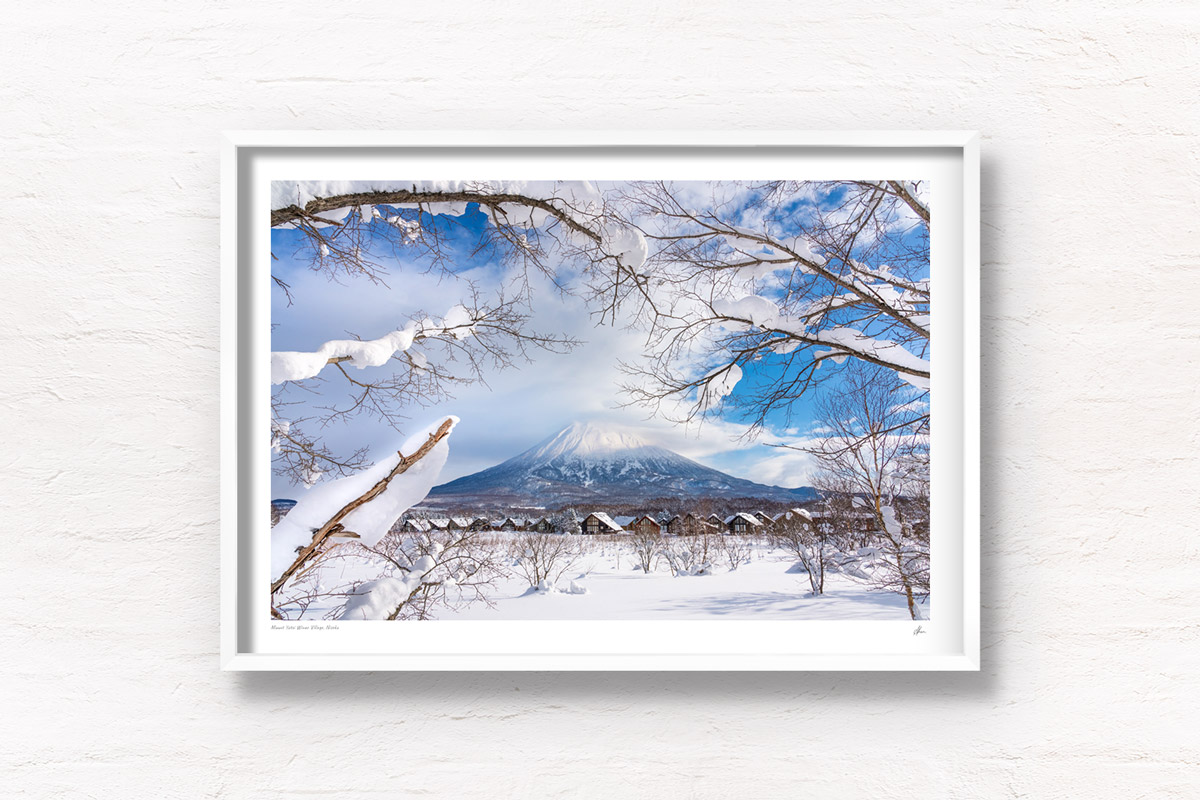 Mount Yotei Winter Village in Niseko on a snowy blue sky day. Framed art photography, wall art prints by Allan Chan.