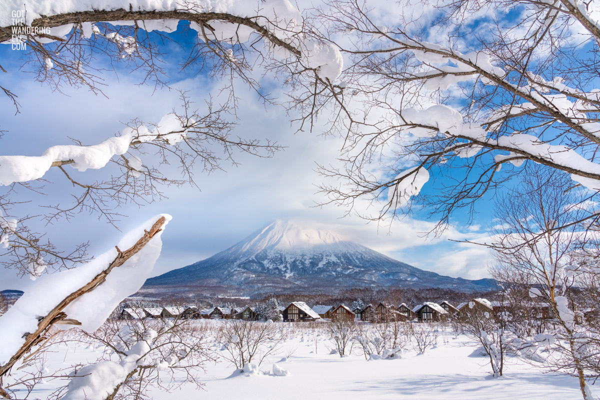 Mount Yotei Winter Village in Niseko on a snowy blue sky day.