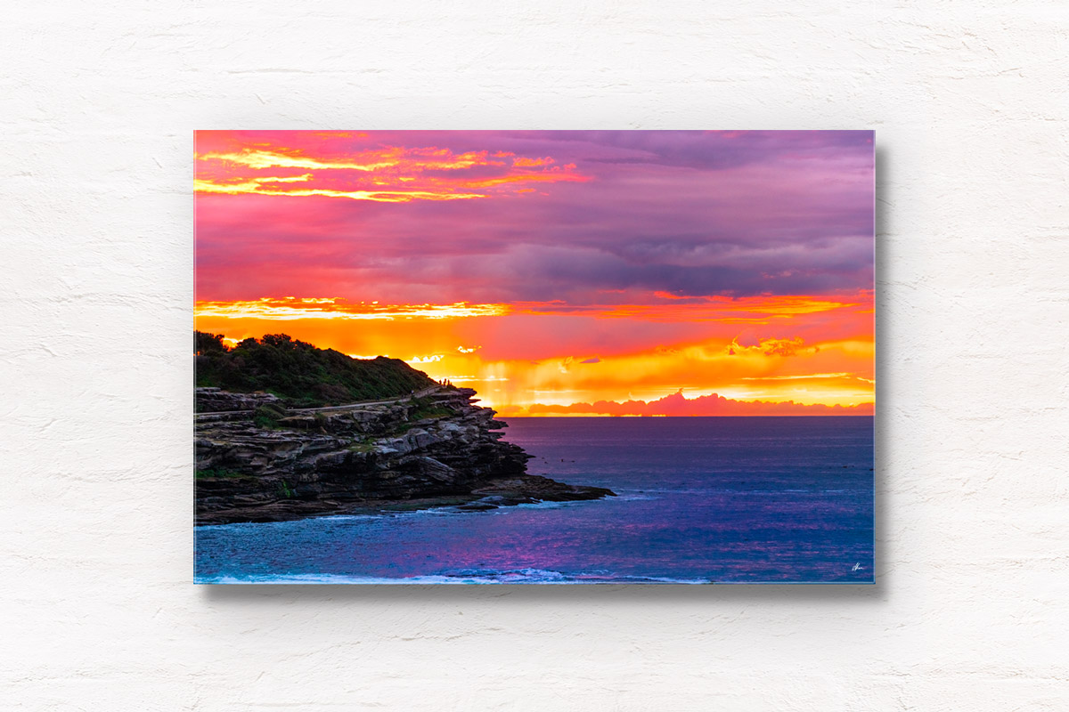 Fiery orange sky rising above MacKenzies Point. Tamarama Sunrise of the coastal walk, Sydney. Wall Art Print.