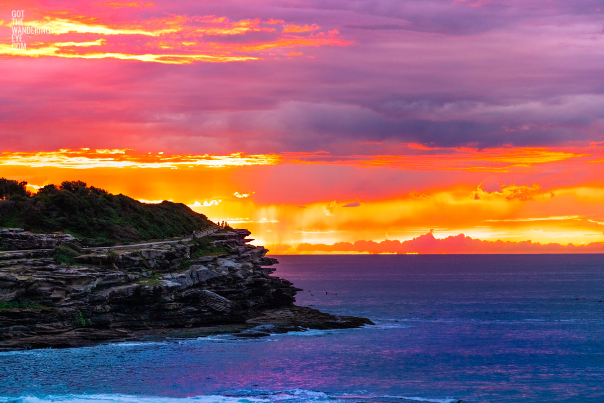 Fiery orange sky rising above MacKenzies Point. Tamarama Sunrise of the coastal walk, Sydney. Wall Art Print.